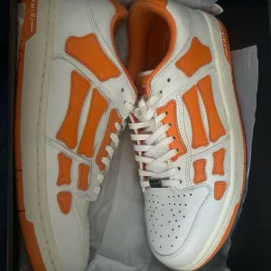 AMIRI White and Orange Sneakers with Geometric Accents