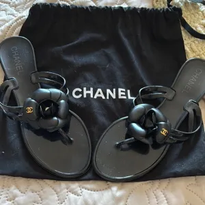 CHANEL Black Sandals with Camellia Embellishment